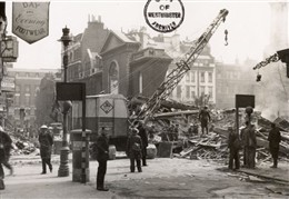 Photo:Black and white photograph of Old Compton Street at the south west corner of Dean Street, including the tower of the church of St Anne, Soho (bomb incident number 1522), 11 May 1941